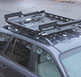 looking down at a small black revrack tray with ski racks and soft pads attached, atop a navy blue hun die